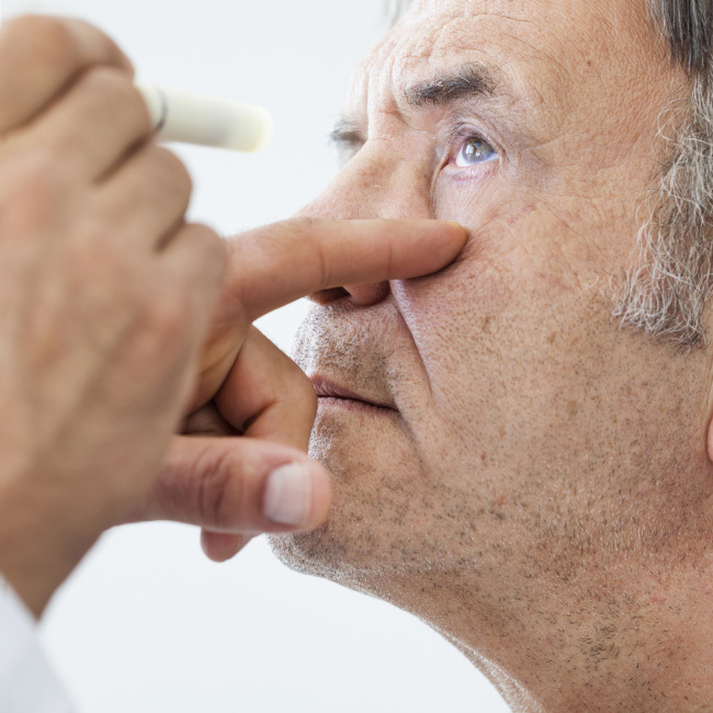 Close-up of man having his eye tested by doctor