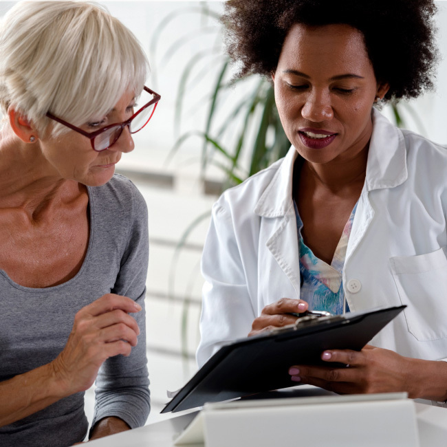 Female doctor explaining test results to elderly patient