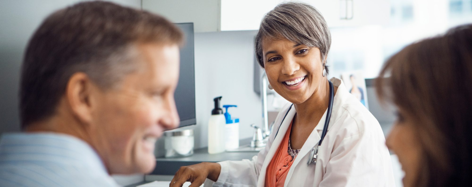 Doctor smiling discussing with patients