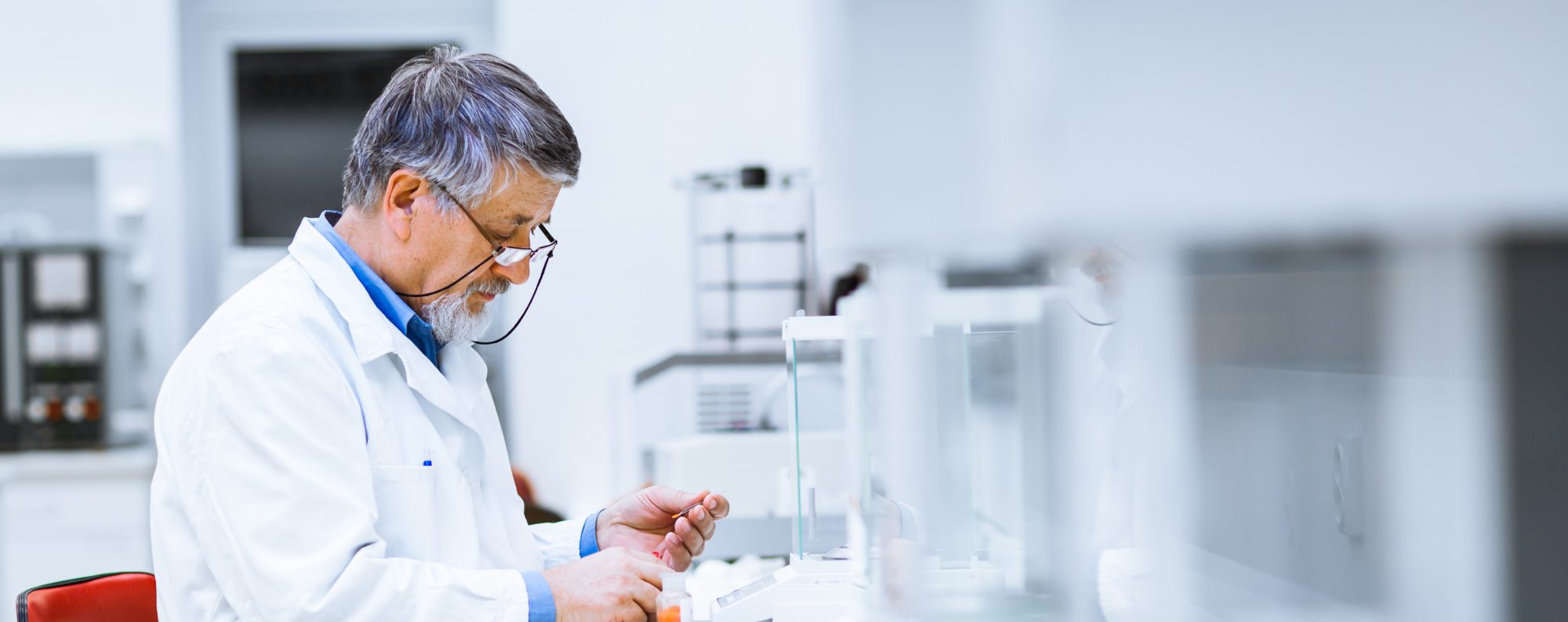 Older male researcher in lab working on project